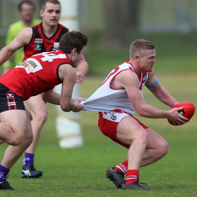 Stawell’s Jesse Barber stops Ararat’s Robert Armstrong from breaking away.