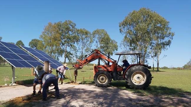 Boondooma Homestead volunteers installing the solar panels for their water bore they purchased with an RACQ Foundation grant.