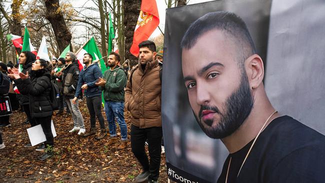 Protesters in Netherlands hold flags and posters of Iranian hip-hop artist Toomaj Salehi who was arrested for backing anti-government protests. Picture: Charles M. Vella/SOPA Images/LightRocket via Getty