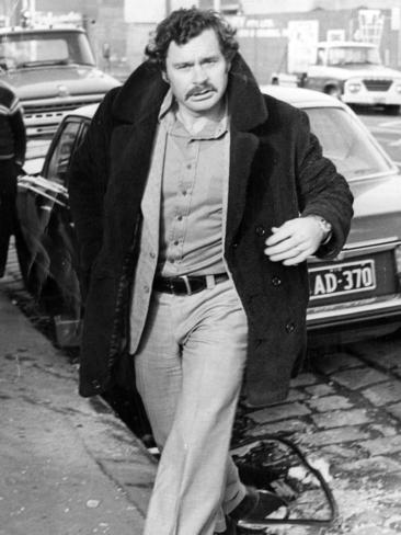 North Melbourne coach Ron Barassi walks away from the accident in which his blue Mercedes collided with another car in 1975.