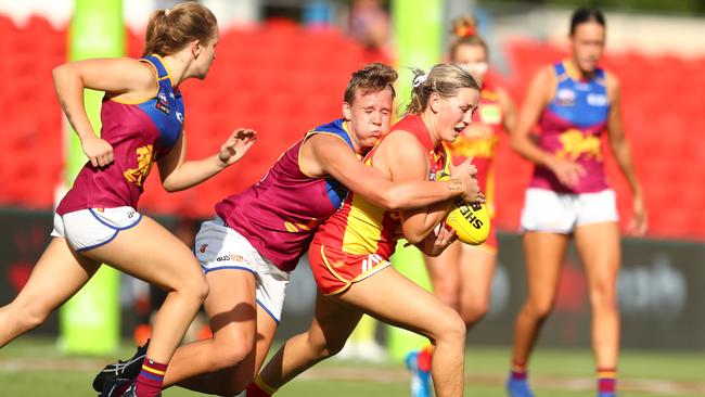 GOLD COAST, AUSTRALIA - FEBRUARY 22: Dee Heslop of the Suns is tackled during the round three AFLW match between the Gold Coast Suns and the Brisbane Lions at Metricon Stadium on February 22, 2020 in Gold Coast, Australia. (Photo by Chris Hyde/Getty Images)