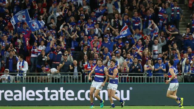 Western Bulldogs fans celebrate after a Marcus Bontempelli goal.