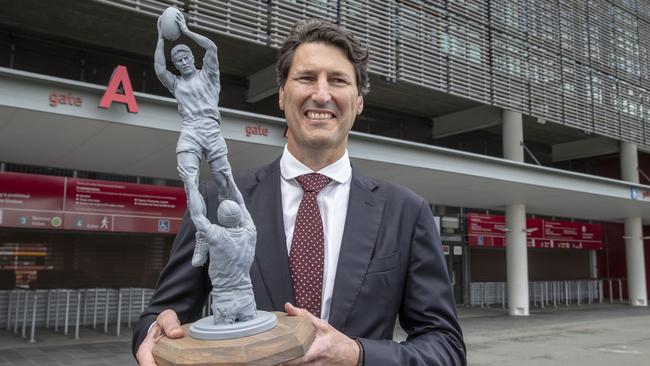 Former Queensland and Wallabies captain John Eales stands next to a scaled model of a statue of himself at Suncorp Stadium. Picture: AAP.