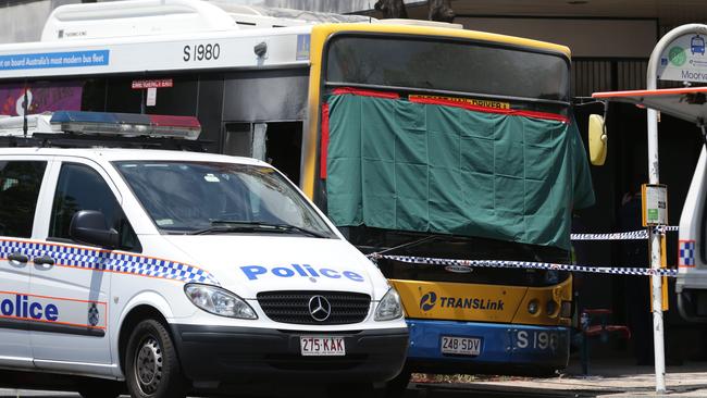 Police at the scene of a fire in Moorooka in which a bus driver was killed. A man has been charged with murder, 11 counts of attempted murder and arson.