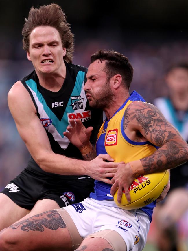 Jared Polec tries to stop Chris Masten in his tracks. Picture: James Elsby/AFL Media/Getty Images