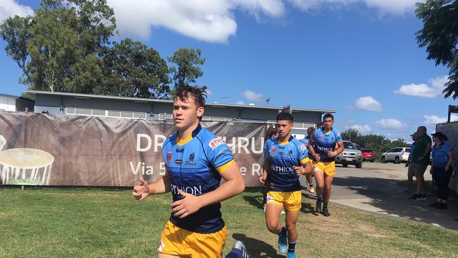 The Norths Meninga Cup team runs onto the field.