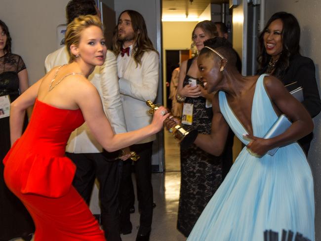 Actresses Jennifer Lawrence and Lupita Nyong'o backstage during the Oscars held at Dolby Theatre in 2014. Picture: Christopher Polk/Getty
