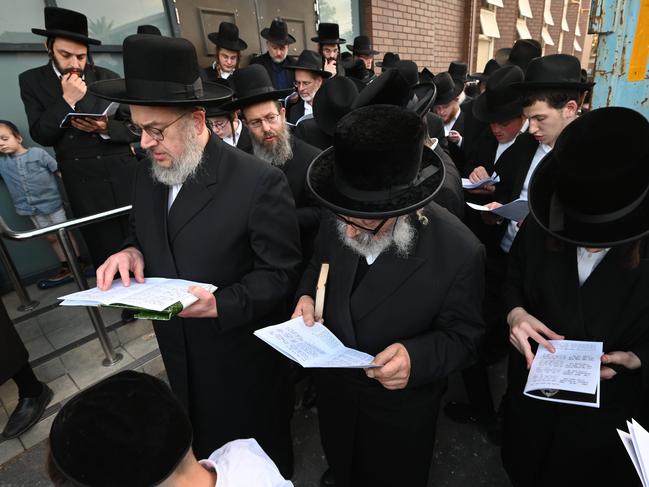 The firebombed Adass Israel Synagogue in Ripponlea, Melbourne, holds a ceremony at tonight where Rabbi Kohn blesses some of the items that were burned in the fire the other week. They have cleared out all the holy books and placed them in a skip. This blessing was held alongside community members only for men. Picture: Tony Gough