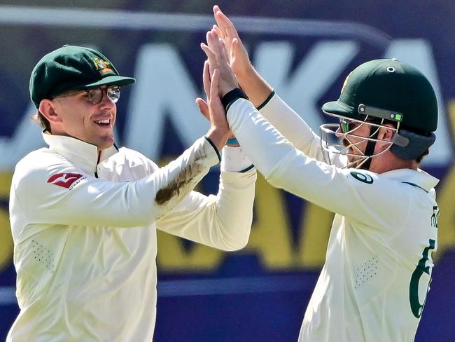 Todd Murphy celebrates with Travis Head after taking a catch to dismiss Sri Lanka's Kusal Mendis. Picture: AFP