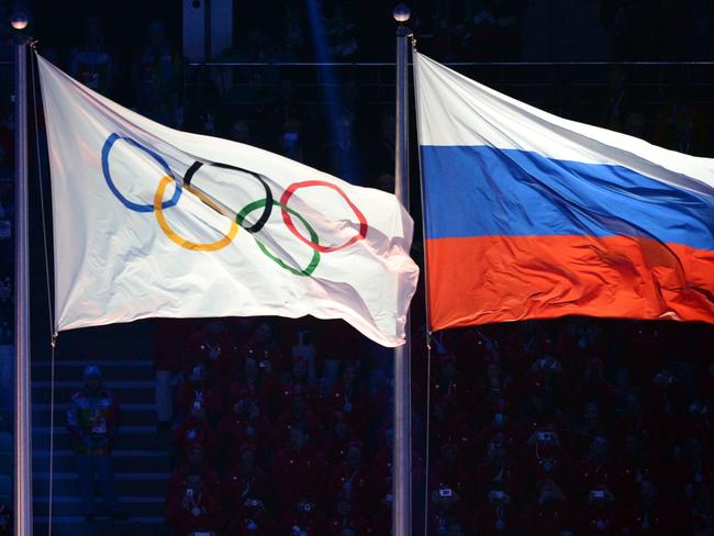 (FILES) This file photo taken on February 7, 2014 shows the Olympic and Russian flags during the Opening Ceremony of the Sochi Winter Olympics at the Fisht Olympic Stadium on February 7, 2014 in Sochi. The International Olympic Committee (IOC) said on Julyt 19, 2016 it will study 
