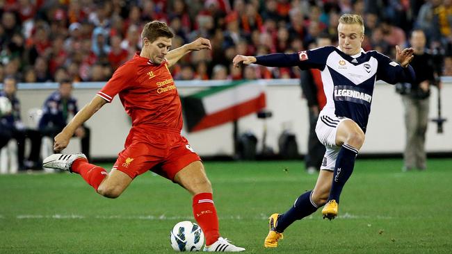 Steven Gerrard gets a kick past James Jeggo.