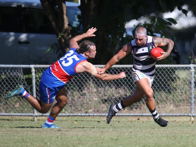 Liam Brandt palms off Jack Taylor in the AFL Cairns seniors match between Centrals Trinity Beach Bulldogs and Port Douglas Crocs, held at Crathern Park, Trinity Beach. Picture: Brendan Radke