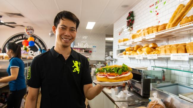 Long Tran, the owner of the new Gatton Bakehouse, in the Gatton Square, with his famous Vietnamese roll. Photo: Ali Kuchel