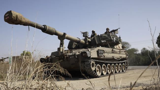 Israeli artillery vehicles travel near the border with the Gaza Strip in Sderot, Israel. Photo by Amir Levy/Getty Images