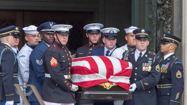 Honour guards carry the casket of Senator John McCain out of the Washington National Cathedral. Photo: Getty Images