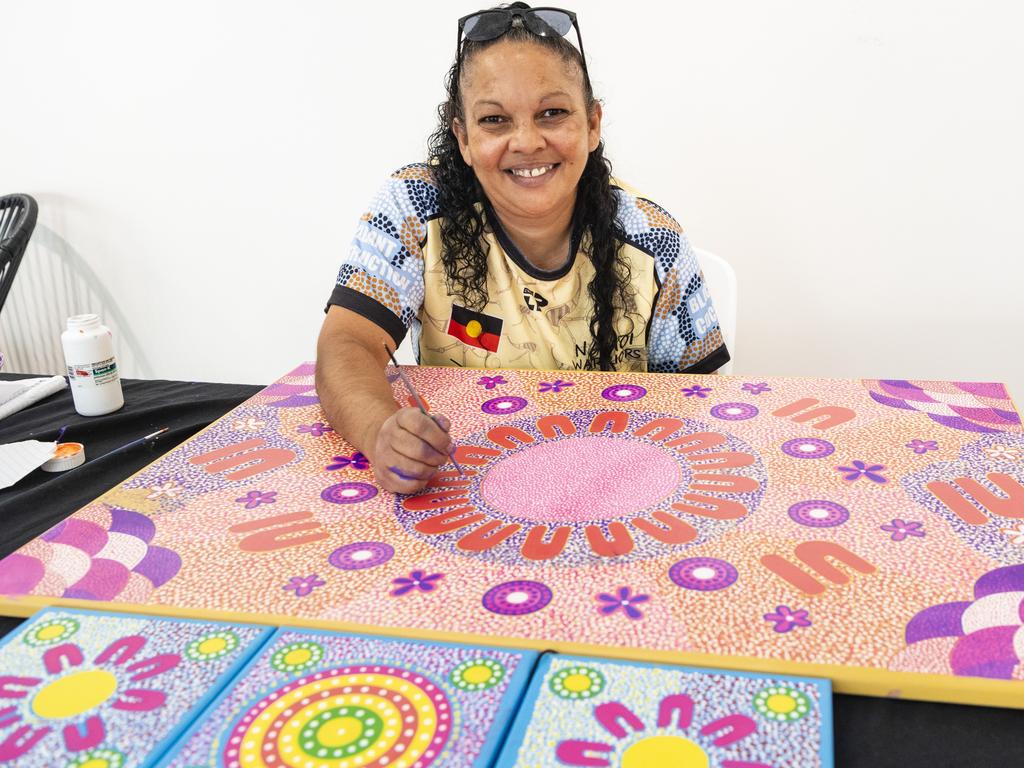 Stacey Trindall of Baru Maranga Art works on a piece of art at her stall at the Indigenous Artisan Markets at The Lighthouse, Saturday, December 17, 2022.