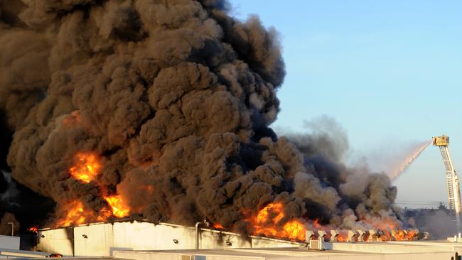 Smoke billows from the factory. Picture: Andrew Henshaw