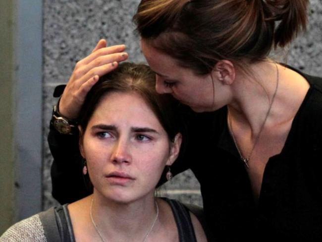 Amanda Knox is comforted by her sister, Deanna Knox, in 2011. A stolen kiss from her prison friend ‘Leny’ was a step too far, she says. Picture: AP