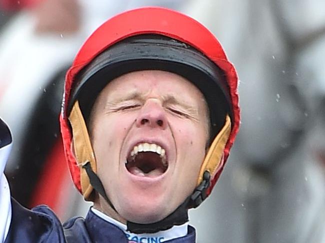 Kerrin McEvoy reacts after winning the Melbourne Cup on Almandin at Flemington Racecourse in Melbourne on November 1, 2016. Almandin pipped Heartbreak City in a thrilling finish to the Melbourne Cup on November 1, giving Australian owner Lloyd Williams a record fifth win in the 'race that stops a nation'. / AFP PHOTO / Paul CROCK / IMAGE STRICTLY RESTRICTED TO EDITORIAL USE – STRICTLY NO COMMERCIAL USE