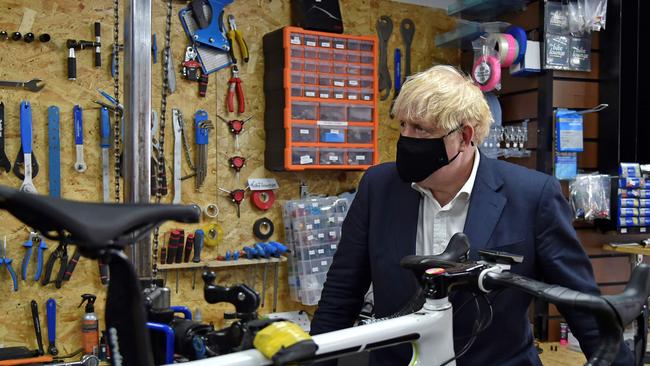 Britain's Prime Minister Boris Johnson at a bicycle repair shop in Beeston, central England. Picture: AFP.