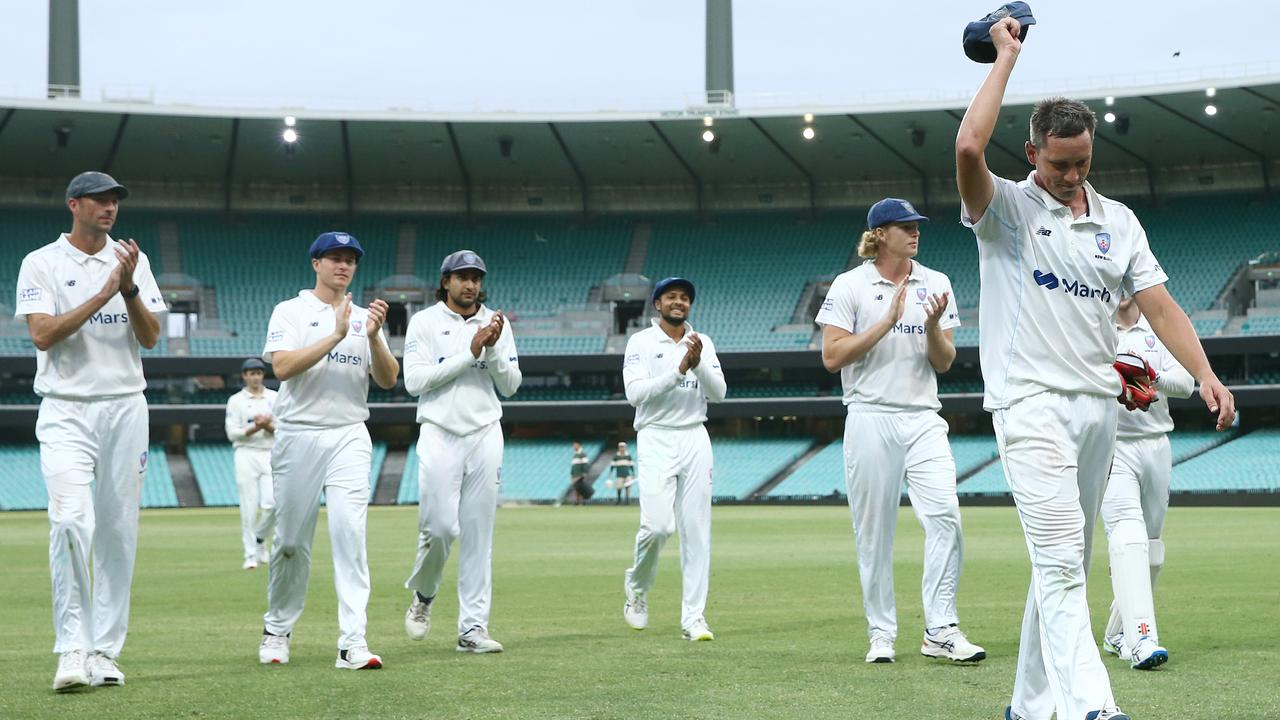 Chris Tremain of the Blues leads his teammates off the field after taking five wickets in the first innings. Photo by Jason McCawley/Getty Images