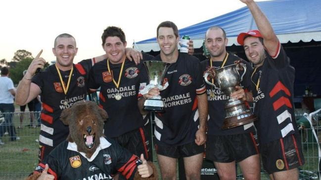 Winners are grinners: (L-R) Bart Masters, Ben Fryer, Matt Macbeth, Matt McCauley, Tod Pes and 'Bailey the Bear'. Picture: Oakdale Workers