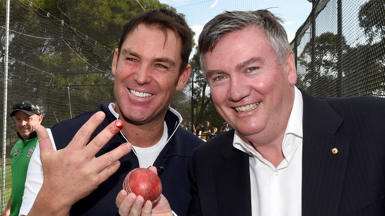 Shane Warne displays the injured finger on his bowling hand after bowling a few deliveries to Eddie McGuire.