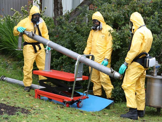 Detectives remove sophisticated drug production equipment from a clandestine drug lab found at Morphett Vale. Picture: Dean Martin