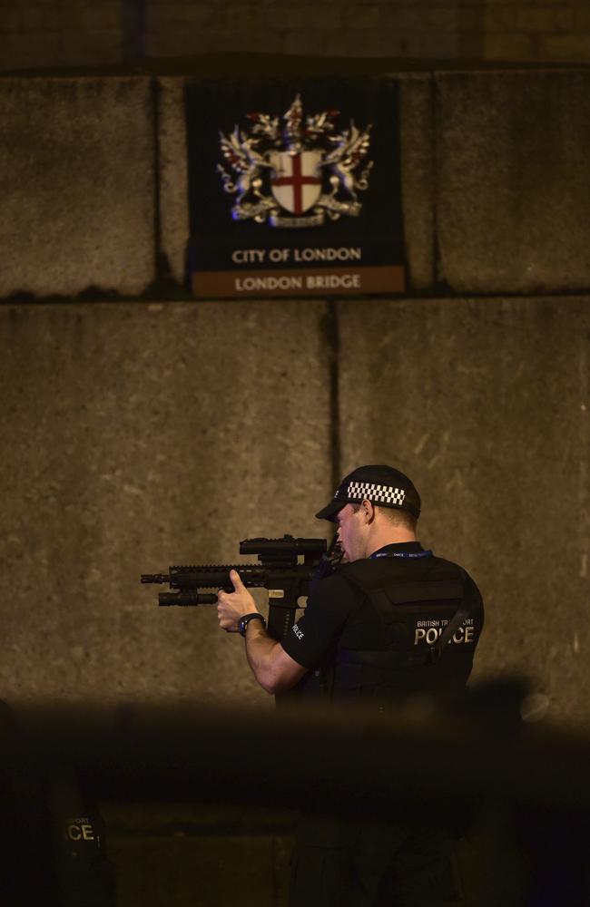 An armed Police officer looks through his weapon on London Bridge. Picture: AP