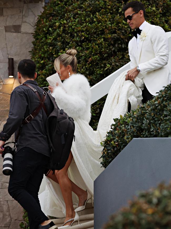 First duties as husband? Rescue the bride’s train. Picture: Adam Yip