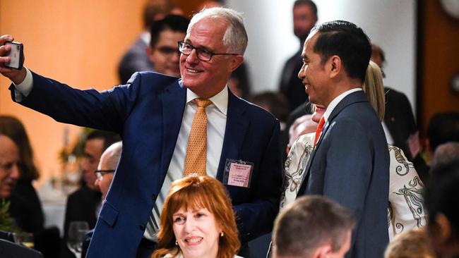 Former Australian Prime Minister Malcolm Turnbull (left) takes a selfie with Indonesia’s President Joko Widodo as they attend an official luncheon at the Great Hall at Parliament House in Canberra last month. Picture: AFP