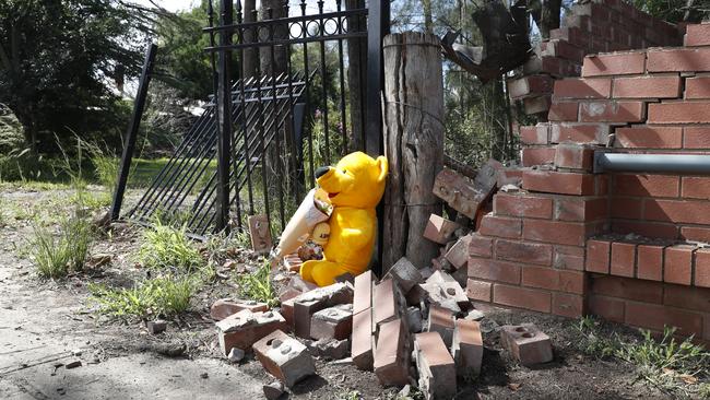 Children’s toys and flowers left at crash scene today. Picture: Jonathan Ng