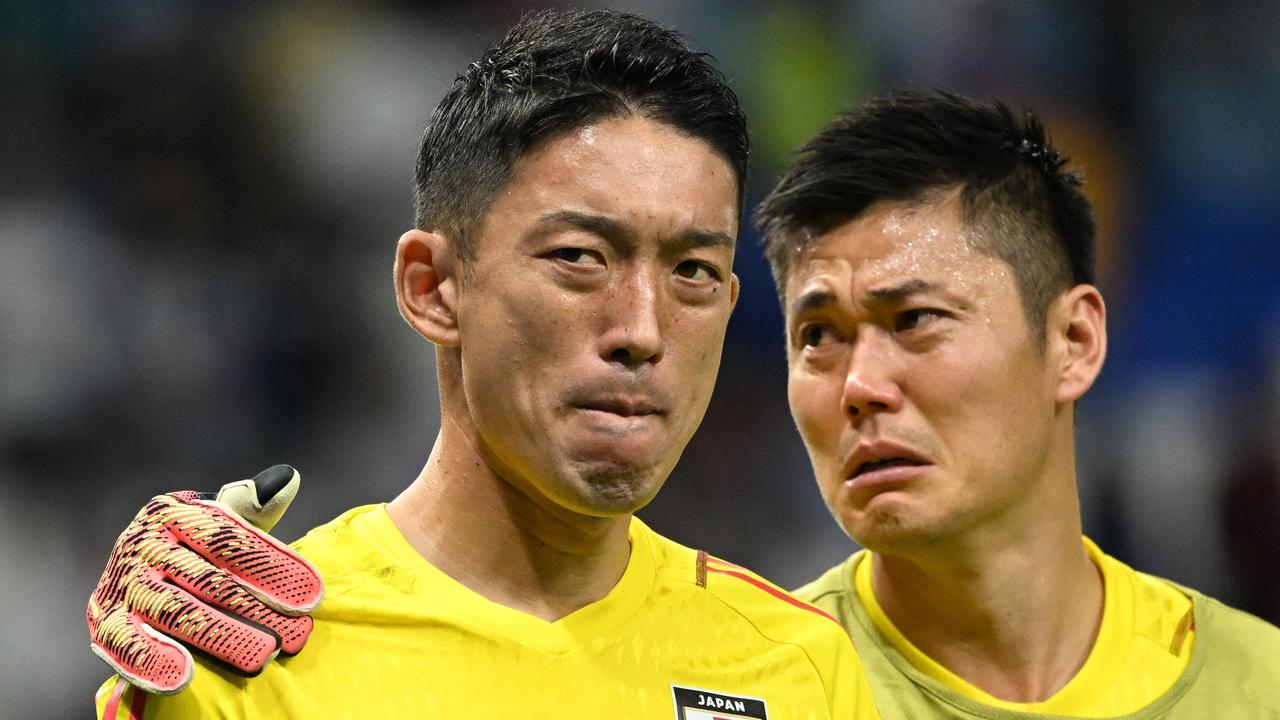 Japan's goalkeeper Shuichi Gonda and Eiji Kawashima react to their team's defeat. Photo by Ina Fassbender / AFP.