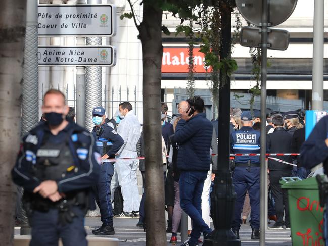 French policemen stand guard after a knife attack in Nice. Picture: AFP