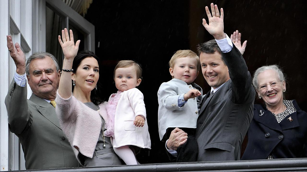 The family, including Crown Prince Consort Henrik and Queen Margrethe, wave from Amalienborg Palace to celebrate Prince Frederik's 40th birthday. Picture: Keld Navntoft/Scanpix/AFP