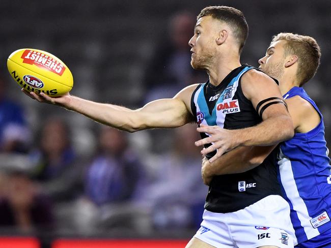 Robbie Gray of the Power takes a mark ahead of Ed Vickers-Willis of the Kangaroos, during the Round 6 AFL match between North Melbourne Kangaroos and Port Adelaide Power at Etihad Stadium in Melbourne, Saturday, April 28, 2018. (AAP Image/Joe Castro) NO ARCHIVING EDITORIAL USE ONLY