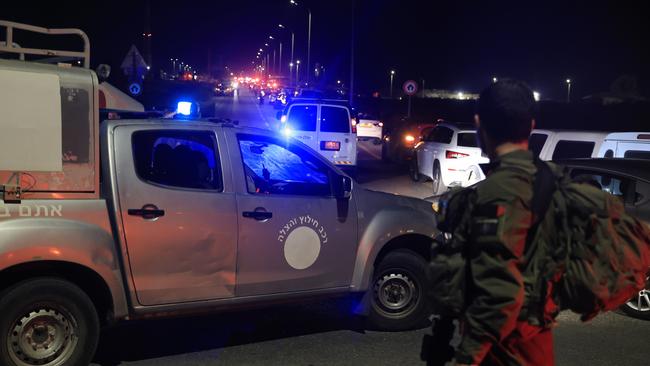 Emergency services personnel attend the scene of the drone strike. Picture: Amir Levy/Getty