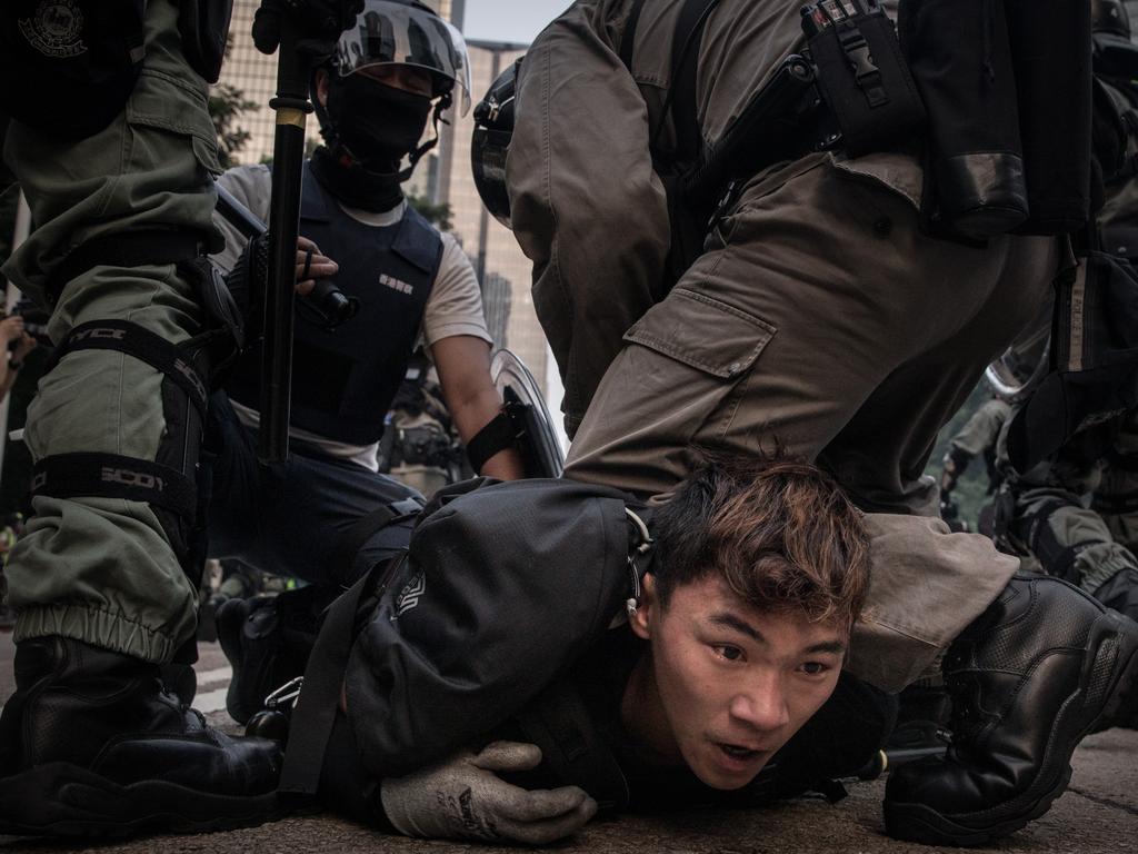 A pro-democracy protester is tackled and arrested by police during clashes after a march in Hong Kong. Picture: Getty