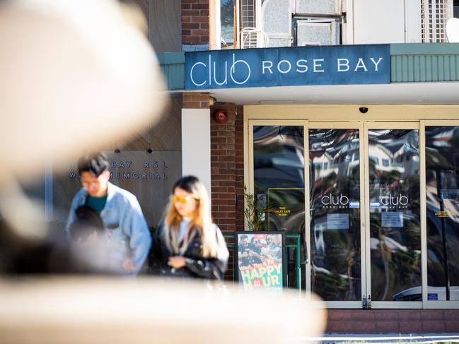 Walkers stroll passed the recently closed Club Rose Bay.Photo: Tom Parrish