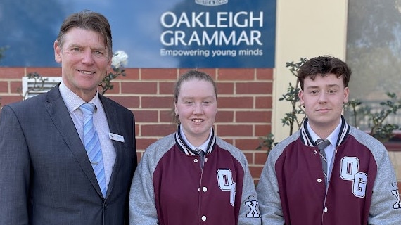 Ella and Anthony came to the aid of an elderly woman who fell outside Oakleigh station. Pictured with school principal Mark Robertson. Picture: Gemma Scerri.