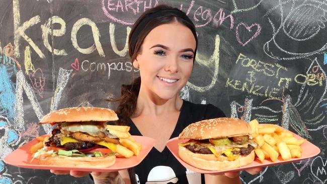 Brittany Partridge with a burger with the lot and a cheese burger at Feed the Earthlings. Picture: Richard Gosling