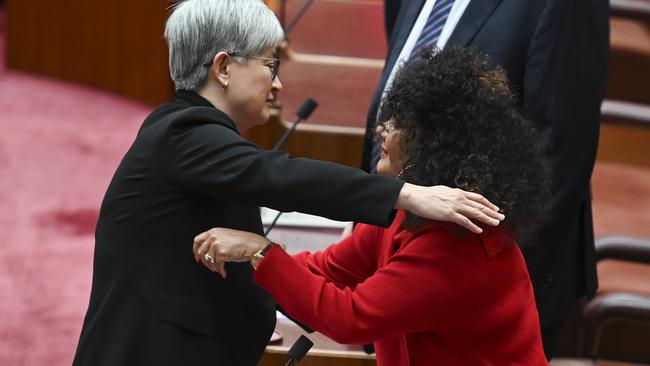 Penny Wong hugs Senator Malarndirri McCarthy as the bill is passed in the Senate. Picture: NCA NewsWire / Martin Ollman.