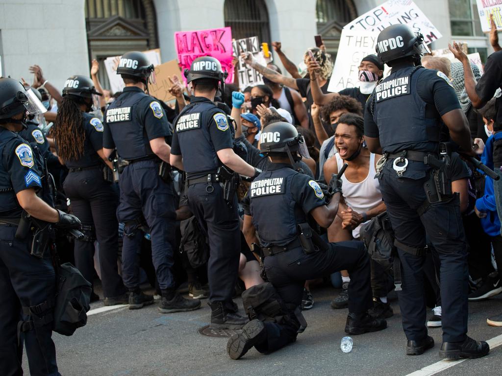 George Floyd riots: Protesters and police ‘fist-bump’ in solidarity ...