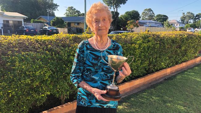 Mary Mills showing off her prized possession – a trophy she won in a waltzing competition.