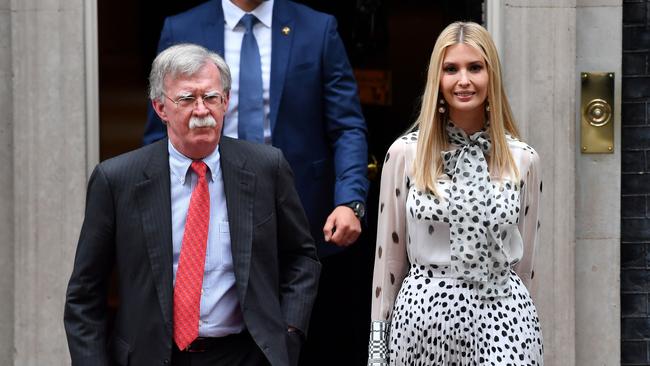 John Bolton (L) and Ivanka Trump leave from 10 Downing Street in London in 2019.