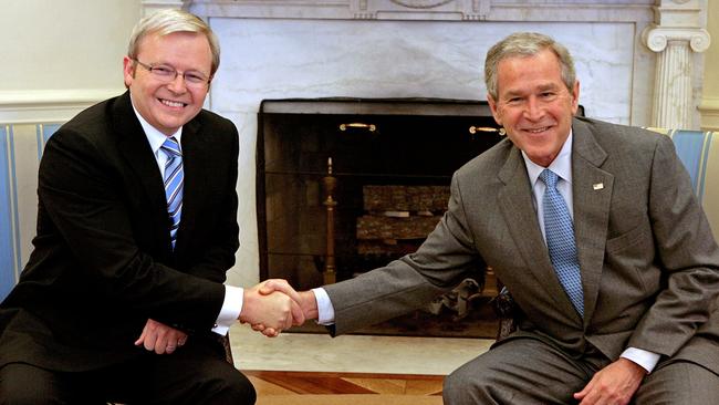 George W. Bush (R) and Kevin Rudd shake hands for the cameras during a meeting in the Oval Office in 2008.