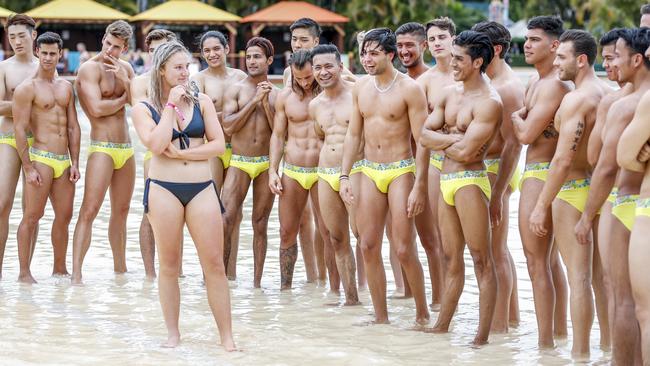 Victorian schoolie Shanae Gribbin, 18, checks out the 20 International male models that are staying on the Gold Coast for the week as they compete for the Manhunt World Finals. Photo: Tim Marsden