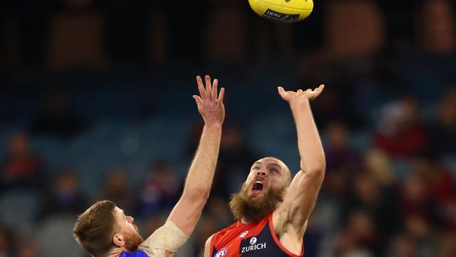 Melbourne ruckman Max Gawn, right, is redefining the power of the big men in Australian football with his work at ground level and in setting up scoring opportunities for his Demon team-mates. Picture: Scott Barbour (Getty Images)