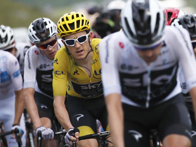 Britain's Chris Froome, second left, follows teammate Britain's Geraint Thomas, wearing the overall leader's yellow jersey