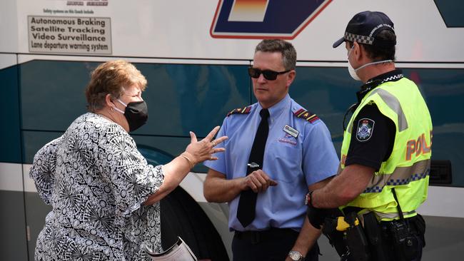 Police remove Karen Warren from a bus at the Queensland border on the last day before the border closes. Picture: NCA NewsWire/Steve Holland